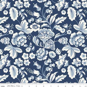 May include: A fabric with a floral pattern featuring large, stylized flowers and leaves in shades of blue and cream against a dark blue background. The design includes various flower types and leaf shapes, creating a classic, elegant look. The image includes a ruler with inches.