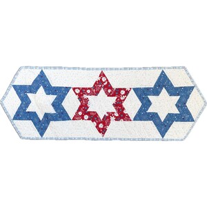 May include: A quilted table runner featuring three six-pointed stars. The stars are in blue and red, with a white background. The blue stars have a snowflake pattern, and the red star has a floral pattern.