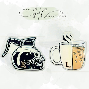 May include: Two die-cut stickers. One is a black and white coffee pot shaped like a skull with the letter "R". The other is a coffee mug with ice cubes and the letter "L". The stickers are on a white background.