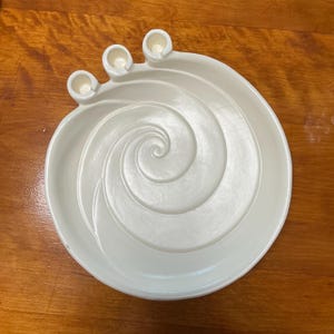 May include: White ceramic candle holder with a spiral design and three candle wells.