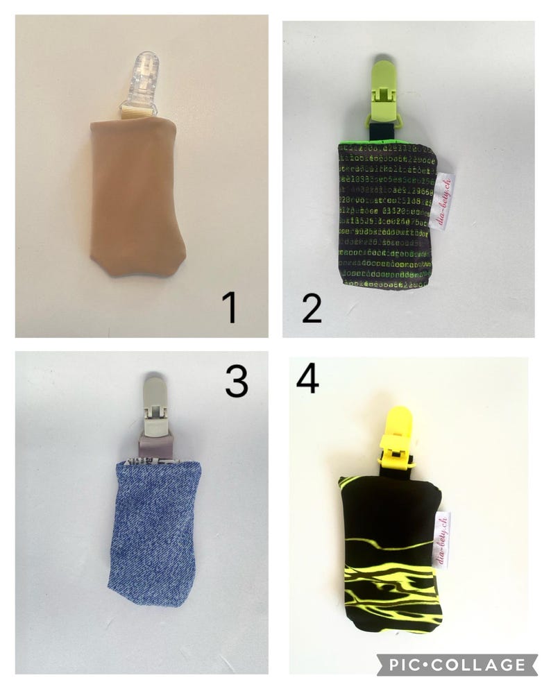 May include: A collage of four pacifier clips. The clips have different fabric designs: tan, black with green text, blue denim, and black with yellow squiggles. Each clip has a plastic clip at the top.