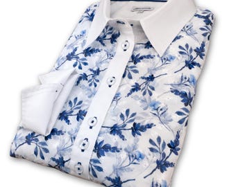 May include: A white long-sleeved button-down shirt with a blue and white floral print. The shirt has a white collar and cuffs.
