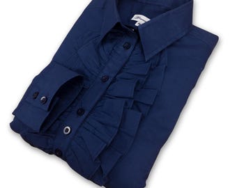 May include: A navy blue long-sleeved shirt with a ruffled front and button closure. The shirt has a classic collar and long sleeves with button cuffs.