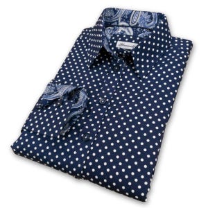 May include: A navy blue long-sleeved shirt with a white polka dot pattern. The shirt has a paisley patterned inner collar and cuffs.