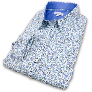 May include: A white button-down shirt with a blue floral pattern and a blue collar.