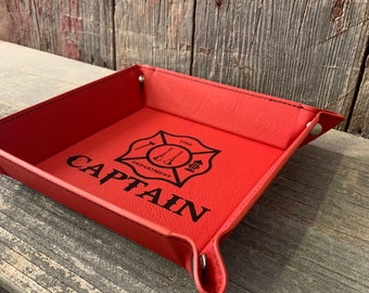 May include: Red leather tray with a fire department logo and the word "CAPTAIN" engraved on it.