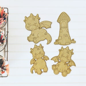 May include: Four unfinished wooden cutouts of a tower and dragons. The tower is brown and has a pointed roof. The dragons are brown and have wings, horns, and closed eyes.