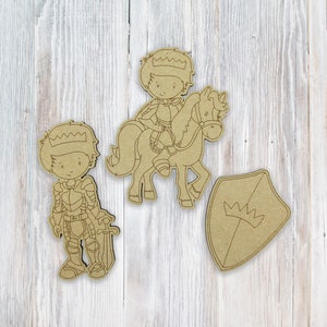 May include: Three wooden cutout figures of a knight, a knight riding a unicorn, and a shield with a crown. The figures are unpainted and ready to be decorated.