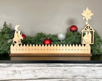 May include: Wooden Christmas advent calendar with a nativity scene, three wise men, and a star on top. The calendar has 25 numbered slots for daily countdown to Christmas.