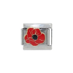 May include: A silver charm bracelet charm featuring a red poppy flower with a black centre.