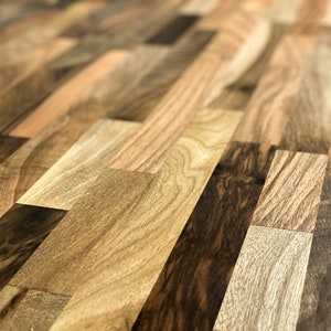 May include: Close-up of a wooden surface with a variety of wood grain patterns. The surface is made of different types of wood, creating a unique and interesting texture.