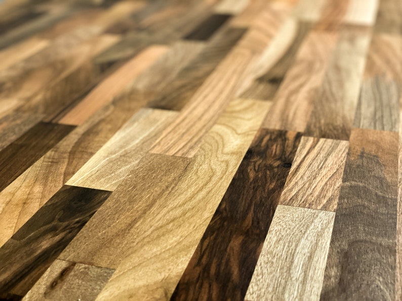 May include: Close-up of a wooden surface with a variety of wood grain patterns. The surface is made of different types of wood, creating a unique and interesting texture.