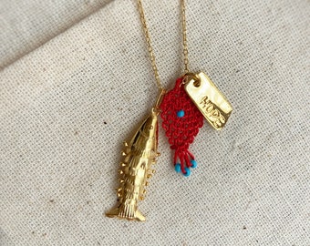 May include: Gold chain necklace with a gold fish charm, a red crocheted heart charm with blue beads, and a gold tag charm with the word "HOPE" engraved on it.