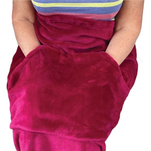 May include: A plush blanket with two large pockets. The blanket is a deep burgundy color.