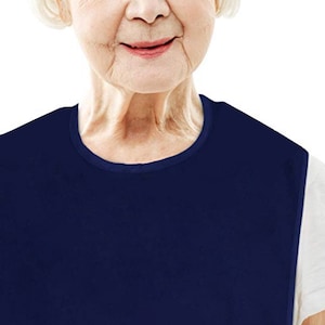 May include: A navy blue bib with a round neckline. The bib is made of a soft, comfortable material and is designed to protect clothing from spills and stains.