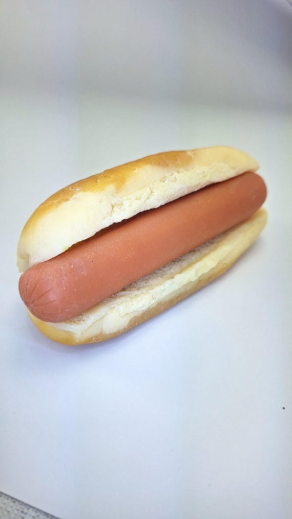 A shockingly realistic hot dog rendered in handmade soap — 16,000+ favorites don't lie, this is peak novelty craft.