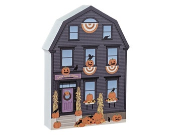 May include: A black and white illustration of a house decorated for Halloween. The house has a sign that says "Crow Haven Corner" and is decorated with pumpkins, crows, and fall foliage.