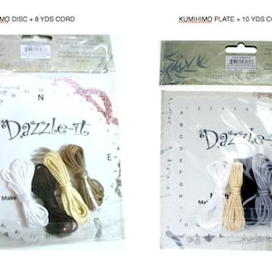 May include: Two Kumihimo kits for making bracelets. The kit on the left includes a circular disc and 8 yards of cord in white, brown, and beige. The kit on the right includes a square plate and 10 yards of cord in white, gray, and brown. Both kits feature the text "Dazzle-it".