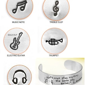 May include: A set of metal stamps featuring musical symbols, including a music note, treble clef, electric guitar, trumpet, and headphones. The stamps are designed for crafting and creating personalized jewelry or other items. The text "Make it yourself with stamps" is also included in the image.