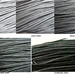 May include: Five spools of waxed cotton cord in various shades of gray, from silver to charcoal. The spools are arranged in a row, with the lightest shade on the left and the darkest shade on the right.
