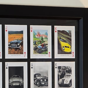 a black framed picture of a collection of cars