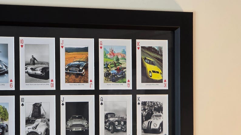 a black framed picture of a collection of cars