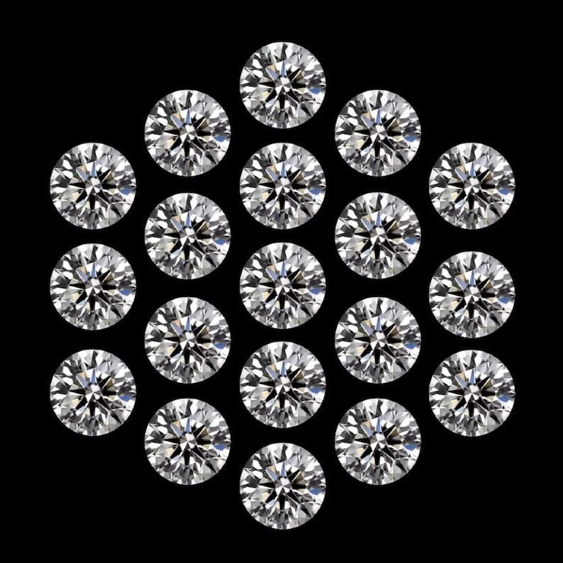 May include: Twenty-one round, brilliant-cut diamonds are arranged in a circular pattern against a black backdrop. The diamonds sparkle with multiple facets, reflecting light. The image showcases the clarity and brilliance of the gemstones.