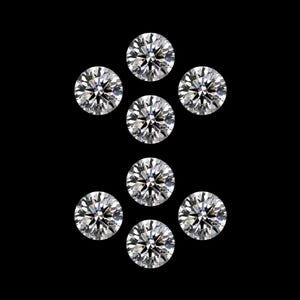 May include: Eight round-cut diamonds displayed against a black backdrop. The diamonds are clear and sparkling, reflecting light. The arrangement suggests a jewelry design or a collection of gemstones. Each diamond is perfectly round.