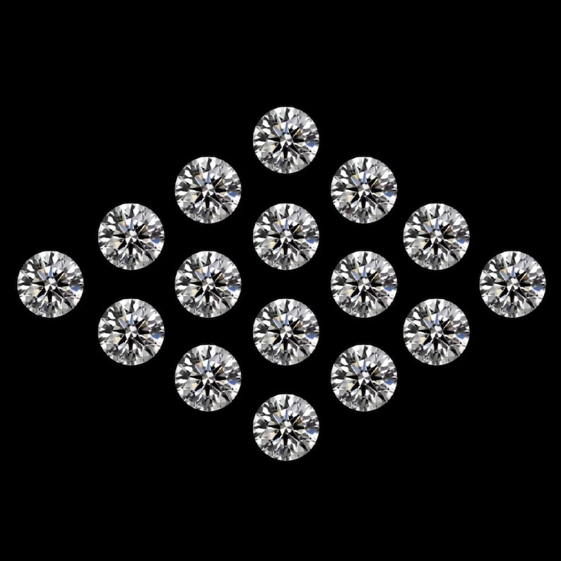 May include: Sixteen round-cut diamonds are arranged in a diamond formation against a black backdrop. The diamonds are clear and sparkling, with multiple facets reflecting light. The gems are brilliant, showcasing their clarity and cut.