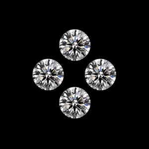 May include: Four round-cut diamonds set against a black backdrop. The gems are clear and sparkling, with numerous facets catching the light. The image showcases the brilliance and clarity of the gemstones, a classic jewellery design.