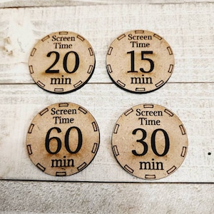 May include: Four wooden tokens with black text that say "Screen Time" and different time amounts in minutes: 20, 15, 60, and 30.