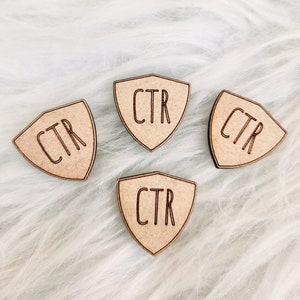 May include: Four wooden shield-shaped tags with the text "CTR" engraved on each.