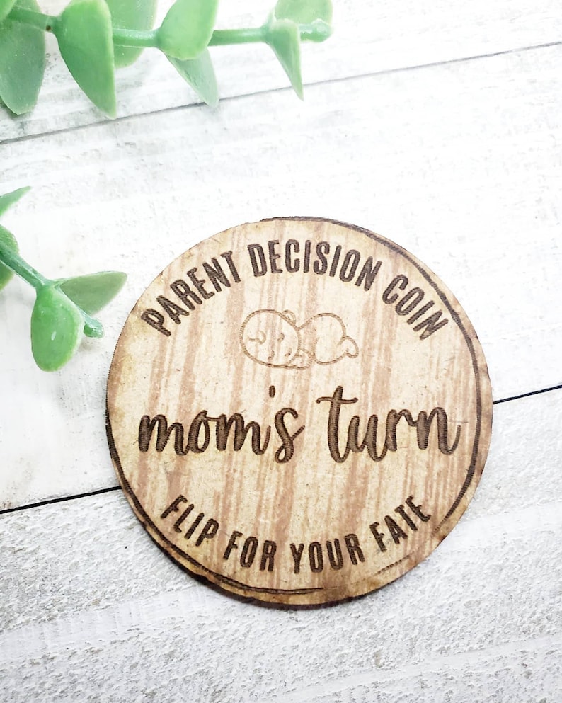 May include: A wooden coin with the text "Parent Decision Coin" and "Mom's Turn" on it. The coin also has the text "Flip for your fate" on it.