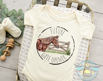 May include: A white baby onesie with a brown horse illustration and the text "Future Gate Opener" in a black circle.