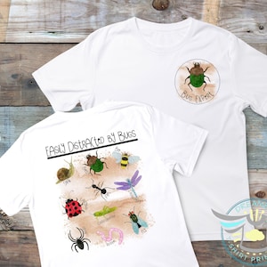 May include: White t-shirt with a bug expert design on the front and a bug-themed design on the back. The back design says "Easily Distracted by Bugs" and features a variety of bugs, including a snail, a beetle, a bee, a butterfly, a ladybug, a grasshopper, a spider, and a worm.
