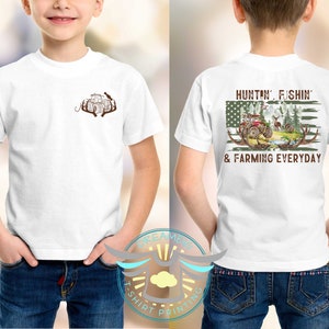 May include: White t-shirt with a brown tractor and antlers on the front and a green, white, and red American flag with a tractor, deer, and trees on the back. The text on the back reads "Huntin', Fishin' & Farming Everyday".
