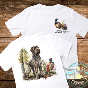 May include: White t-shirt with a brown and white dog and a pheasant on the back. The front of the shirt has a pheasant and the text "Pheasant Hunter".