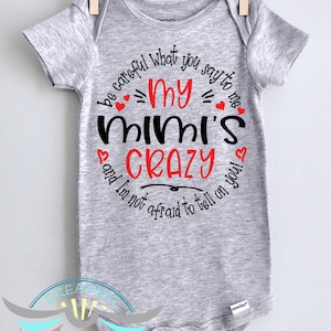 May include: Gray baby onesie with a black and red graphic that says "Be careful what you say to my Mimi's crazy and I'm not afraid to tell on you!"