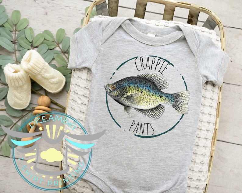 May include: A gray baby onesie with a green circle graphic featuring a black and green crappie fish and the text "Crappie Pants".