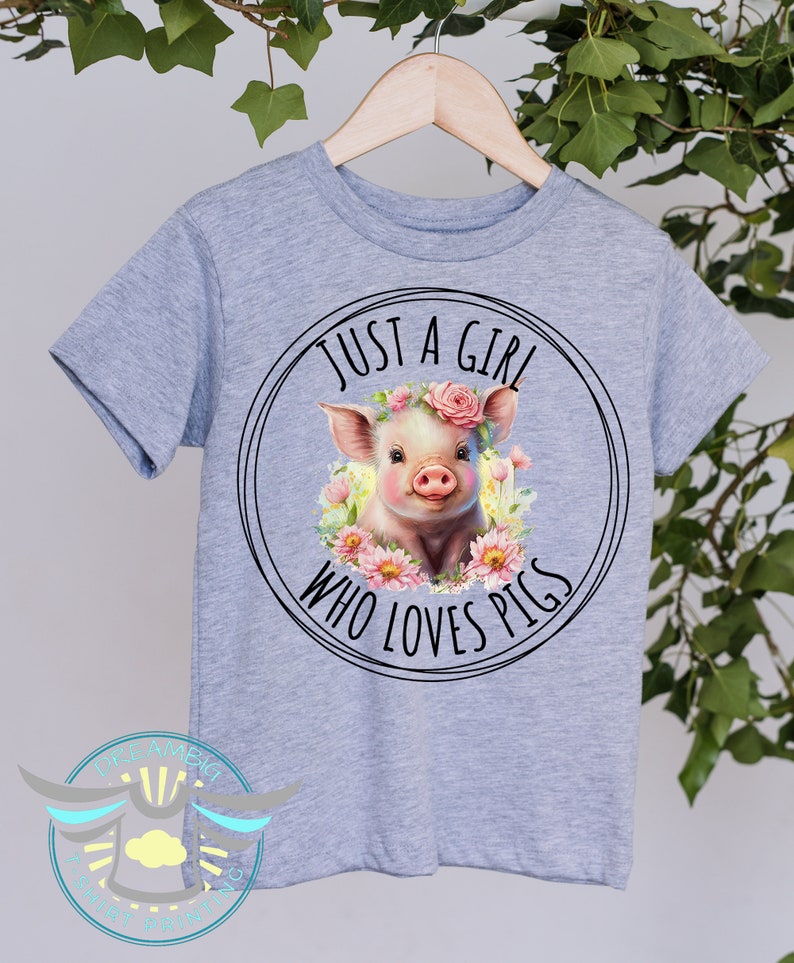 May include: Gray t-shirt with a black circle graphic featuring a pig wearing a pink flower crown and the text "Just a girl who loves pigs".