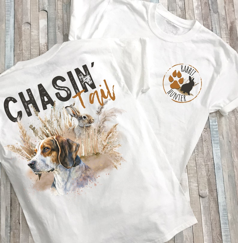 Vintage inspired chasing tail rabbit hunting beagle t-shirt. Show off your love for the hunt with this unique design featuring rabbit chase scene. Perfect for outdoor enthusiasts and hunters, this shirt combines style and passion for the sport.