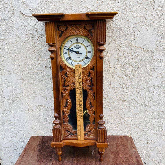 Suspended wall clock made of walnut wood