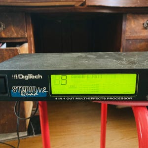 May include: Black Digitech Studio V2 Quad 4 in 4 out multi-effects processor with a green LCD screen displaying "Concert Hall" and a number "18".