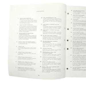 May include: Open textbook page with a table of contents listing topics like "Series and Parallel Equivalent Resistances" and "The Direct Current Motor." The text is black on a white background. The book is open to a double-page spread.