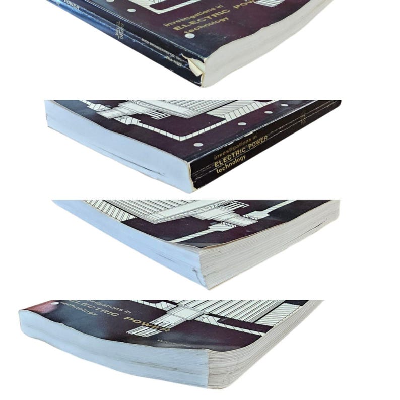 May include: A vintage book titled "Investigations in Electric Power Technology" with a dark cover and white pages. The cover features a geometric design and text in white. The book's edges show signs of wear.