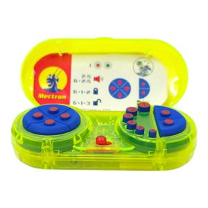 May include: A transparent neon green and yellow electronic device with blue and red buttons. The device has a hinged lid with a printed card inside. The card has the word "Mectron" and various symbols and numbers.