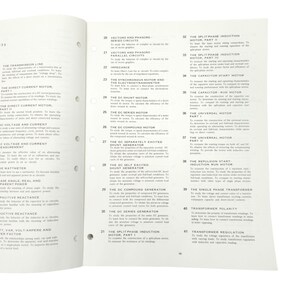 May include: Open book pages with technical diagrams and text. Titles include "Vectors and Phasors," "DC Shunt Motor," and "Transformer Polarity." The pages are white with black text and diagrams, and the book is open on a white surface.