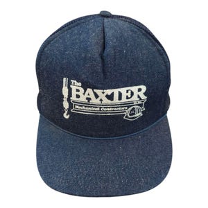 May include: A blue denim trucker hat with a white embroidered logo that reads "The Baxter Mechanical Contractors Inc."