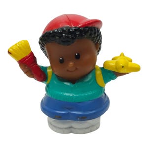 May include: A colorful Little People figure of a child wearing a red cap, green shirt, and blue pants. The figure is holding a yellow airplane in one hand and a red and yellow paintbrush in the other. The figure has black hair and a backpack.