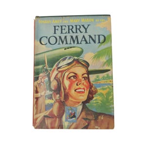 May include: A vintage book cover for "Ferry Command" with a retro design. It shows a woman in a pilot's helmet and goggles, with a green airplane in the background. The cover includes the names Sparky Ames and Mary Mason, and a tropical scene.